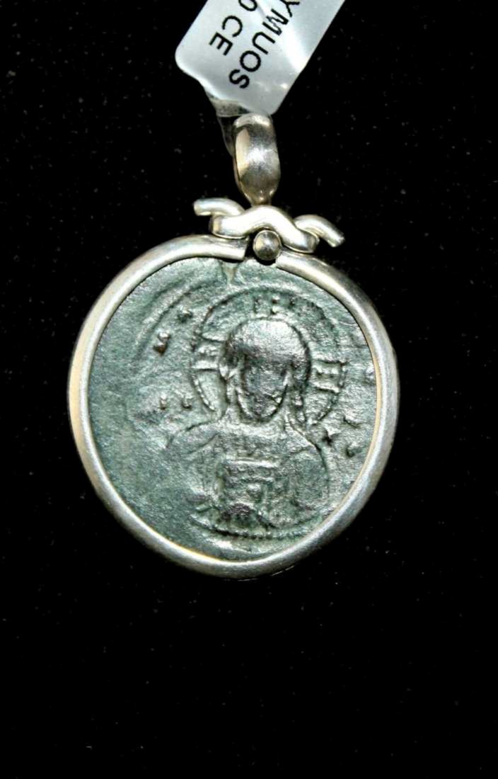 Ancient Byzantine Bronze Coin Of Christ set in pendant: Ancient Byzantine Bronze Coin Of Christ c.1100 AD. Size 1 3/8 inches diameter. Ancient Byzantine Bronze Coin with Christ facing/Reverse with Latin inscriptions. Set in modern Silver Pendant. with susp