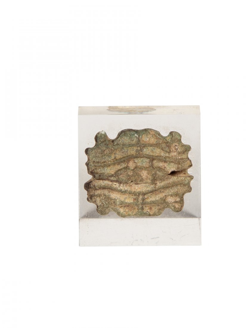 Ancient Egyptian double eye of Horus c.664-332 BC.: Ancient Egyptian double eye of Horus c.664-332 BC. Size 0 7/8 inch. A Green Faience double eye of horus amulet. Mounted on clear plastic stand.