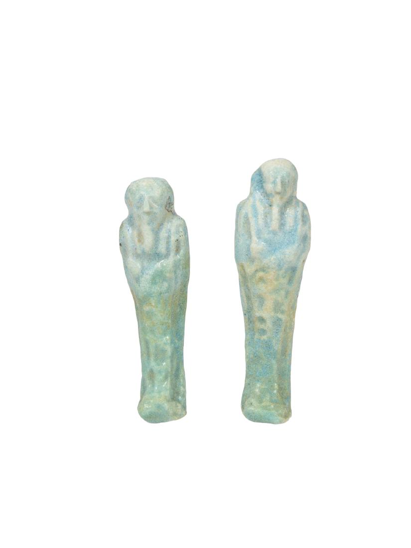 Lot of 2 Ancient EGYPTIAN Faience Ushabties Late Period: Lot of 2 Ancient EGYPTIAN Faience Ushabties Late Period c.664-332 BC BC. Size 3 1/8- 2 7/8 inches high. A mummified form blue faience Ushabti figures, with tripartite wig, beard of Osiris, the arms sh