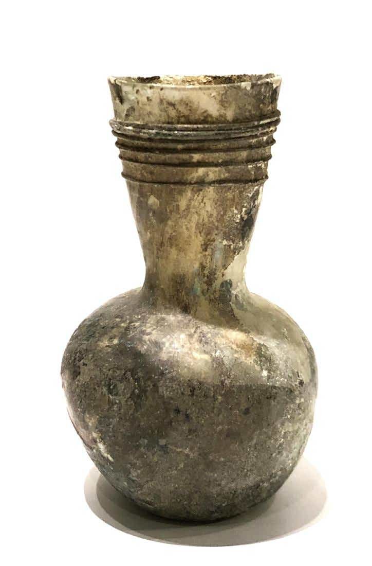 Ancient Roman Glass Bottle c.2nd-4th century AD.: Ancient Roman Glass Bottle c.2nd-4th century AD. Size 4 3/4 inches high. Ancient blown glass bottle with glass threads around the neck. nice patina. Ex Anavian Gallery New York City.