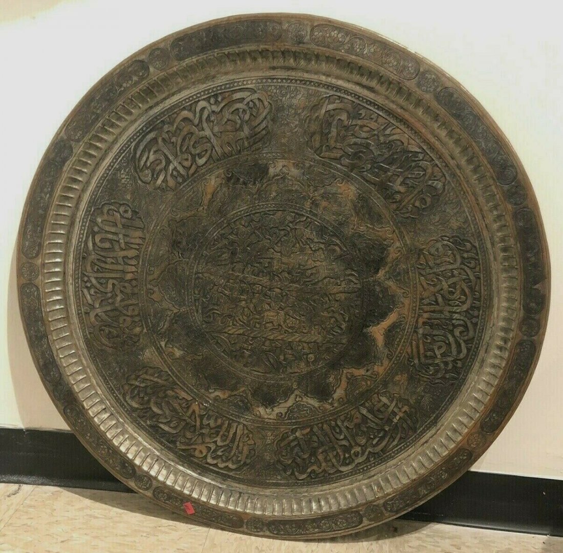 Large Syrian copper tray with Arabic, hunting scene: Large Syrian copper tray with Arabic, hunting scene. Size 30 inches diameter. A large Copper shallow tray hand etched, decorated with Arabic calligraphy and hunting scene.
