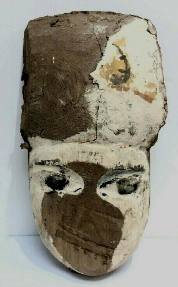 Ancient Egyptian Mummy Wood Mask c.664-332 BC.: Ancient Egyptian Mummy Wood Mask c.664-332 BC. Size 9 inches high x 5 1/2 inches wide. Ancient Egyptian Mummy Wood Mask painted in yellow, black and white over gesso, the forehead decorated with scorp