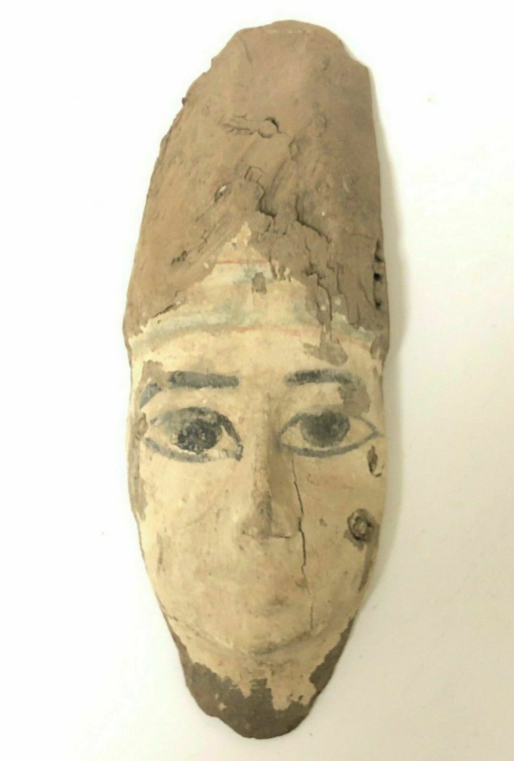 Ancient Egyptian Mummy Wood Mask c.664-332 BC.: Ancient Egyptian Mummy Wood Mask c.664-332 BC. Size 10 1/2 inches high x 4 inches wide. Fine Ancient Egyptian Mummy Wood Mask painted in white and black over gesso. Condition: natural cracks and losse