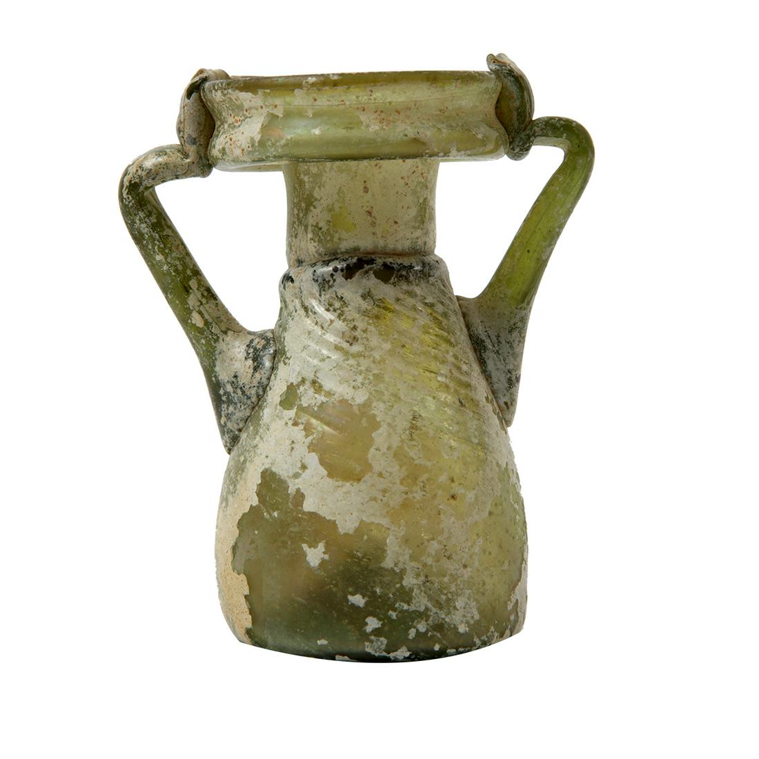 Ancient Holy Land Roman Glass Jar c.1st-2nd century AD.: Ancient Holy Land Roman Glass Jar c.1st-2nd century AD. Size 4 1/4 inches high. Beautiful ancient Roman green glass jar with twin handles, area of iridescent patina. Condition Intact. Provenance Ex To