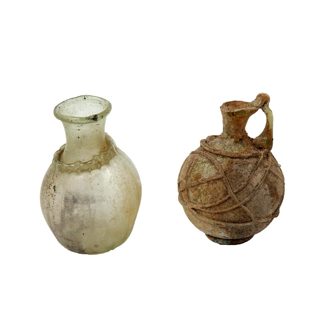Lot of 2 Ancient Roman Glass Bottles c.2nd-4th century: Lot of 2 Ancient Roman Glass Bottles c.2nd-4th century AD. Size 2 7/8 - 3 inches high. Ancient Roman glass jug with thread design together with a bottle, Condition Jug with chips at rim, bottle Intact