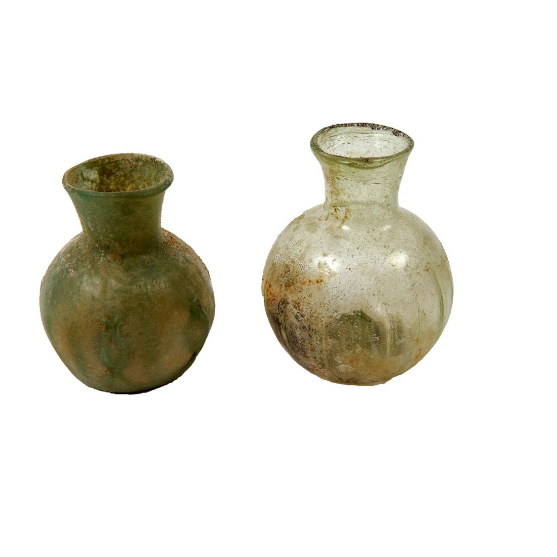 Lot of 2 Ancient Roman Glass Bottles c.2nd-4th century: Lot of 2 Ancient Roman Glass Bottles c.2nd-4th century AD. Size 2 1/2 - 2 3/4 inches high. Lot of 2 Ancient Roman green glass bottles, Condition Intact. Provenance Ex Todd Figi Estate California