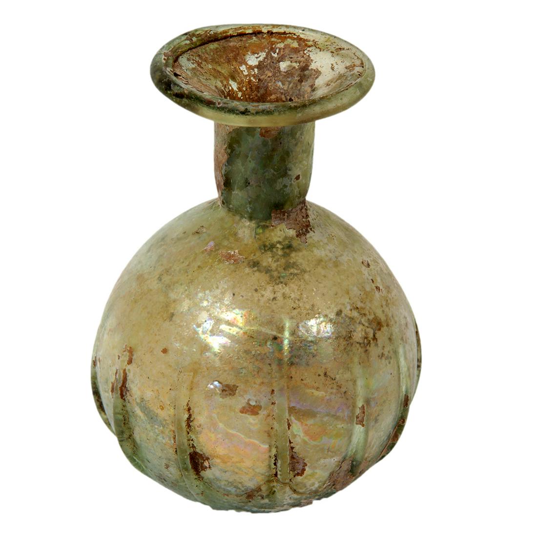 Ancient Roman Glass Sprinkler bottle c.1st-2nd century: Ancient Roman Glass Sprinkler bottle c.1st-2nd century AD. Size 4 3/4 inches high. Beautiful form Sprinkler bottle with ribbed body, lots of iriddesence patina. Ex: Jack P. Minor New York 1950's.