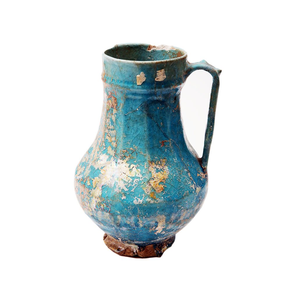 Ancient Persian Islamic Ceramic Jug c.13th century AD.: Ancient Persian Islamic Ceramic Jug c.13th century AD. Size 8 3/8 inches high. A turquoise color glazed footed cermaic jug. Provenance: Ex David Saidian Estate New York city. to present owner by inher