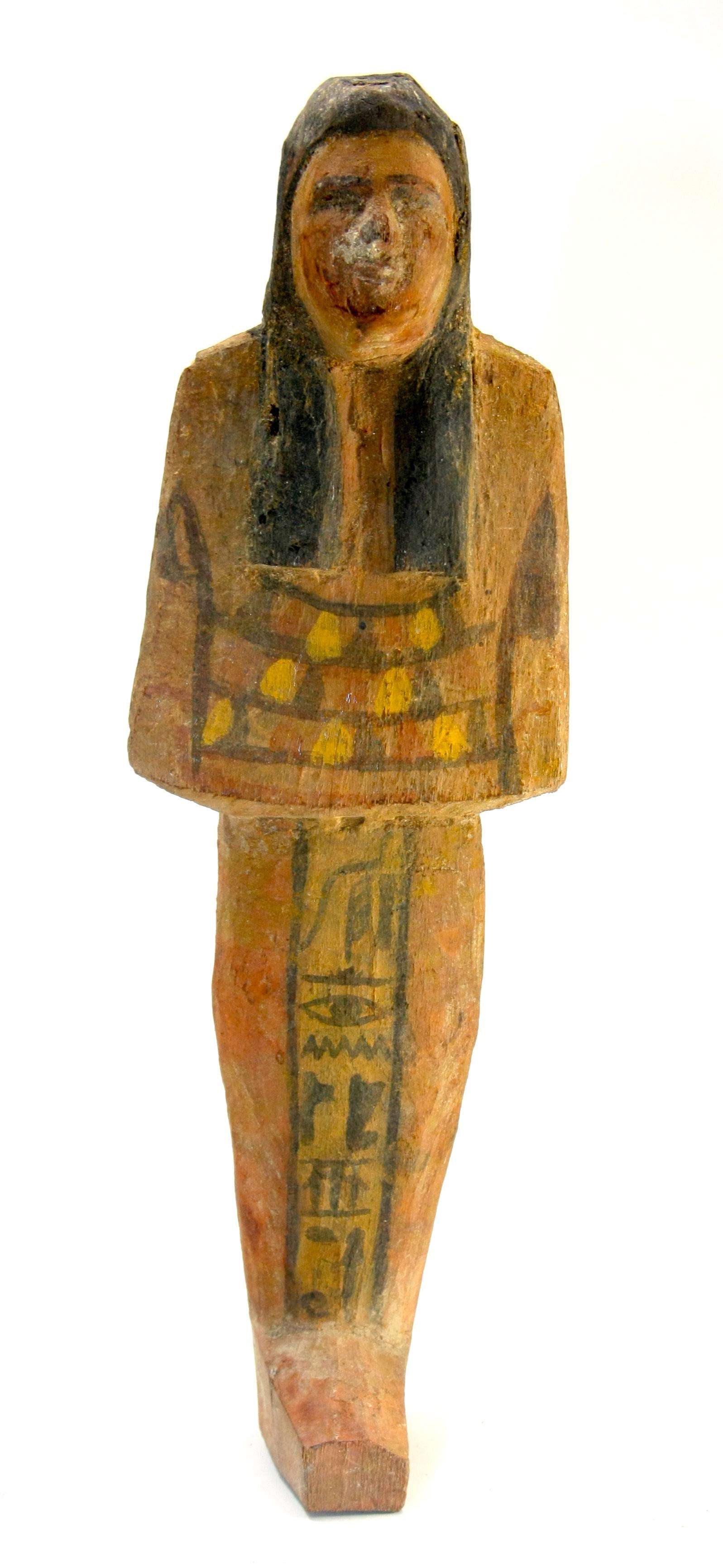 Ancient Egyptian Wood Ushabti Figure c.700 BC.: Ancient Egyptian Wood Ushabti Figure c.700 BC. Size 7 5/8 inches high (19.3 cm). Large carved hardwood ushabti, wearing the royal wig. having vertical glyph register down front leg. Provenance:Private