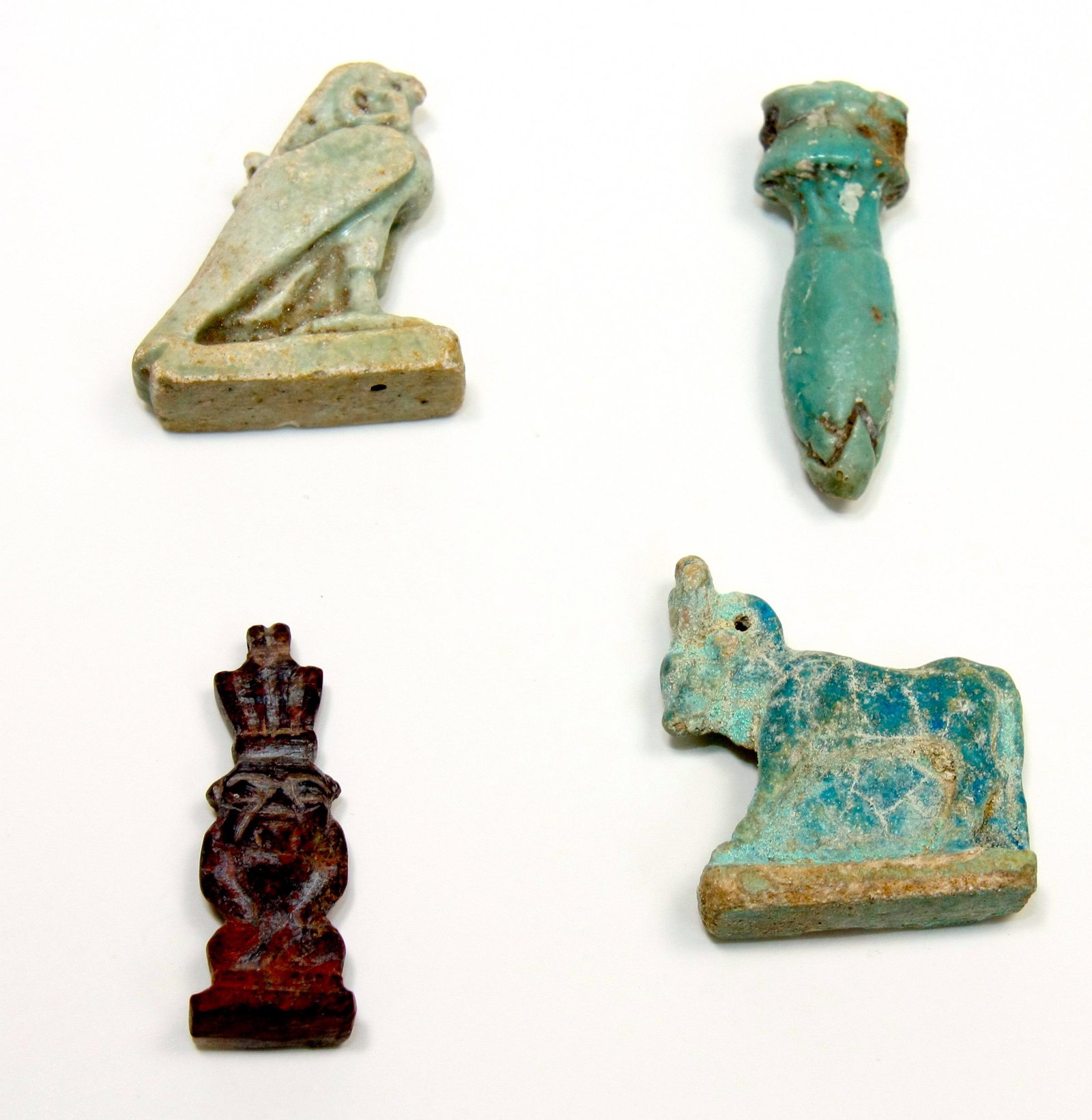 Lot of 4 Ancient Egyptian Faience Amulets Late period: Lot of 4 Ancient Egyptian Faience Amulets Late period c.664-332 BC. Size 1 1/4 - 1 1/8 inch high (3.17 cm) Great lot of 4 Ancient Egyptian Faience amulets consist of Apis Bull, Horus, Papyrus Amulet t