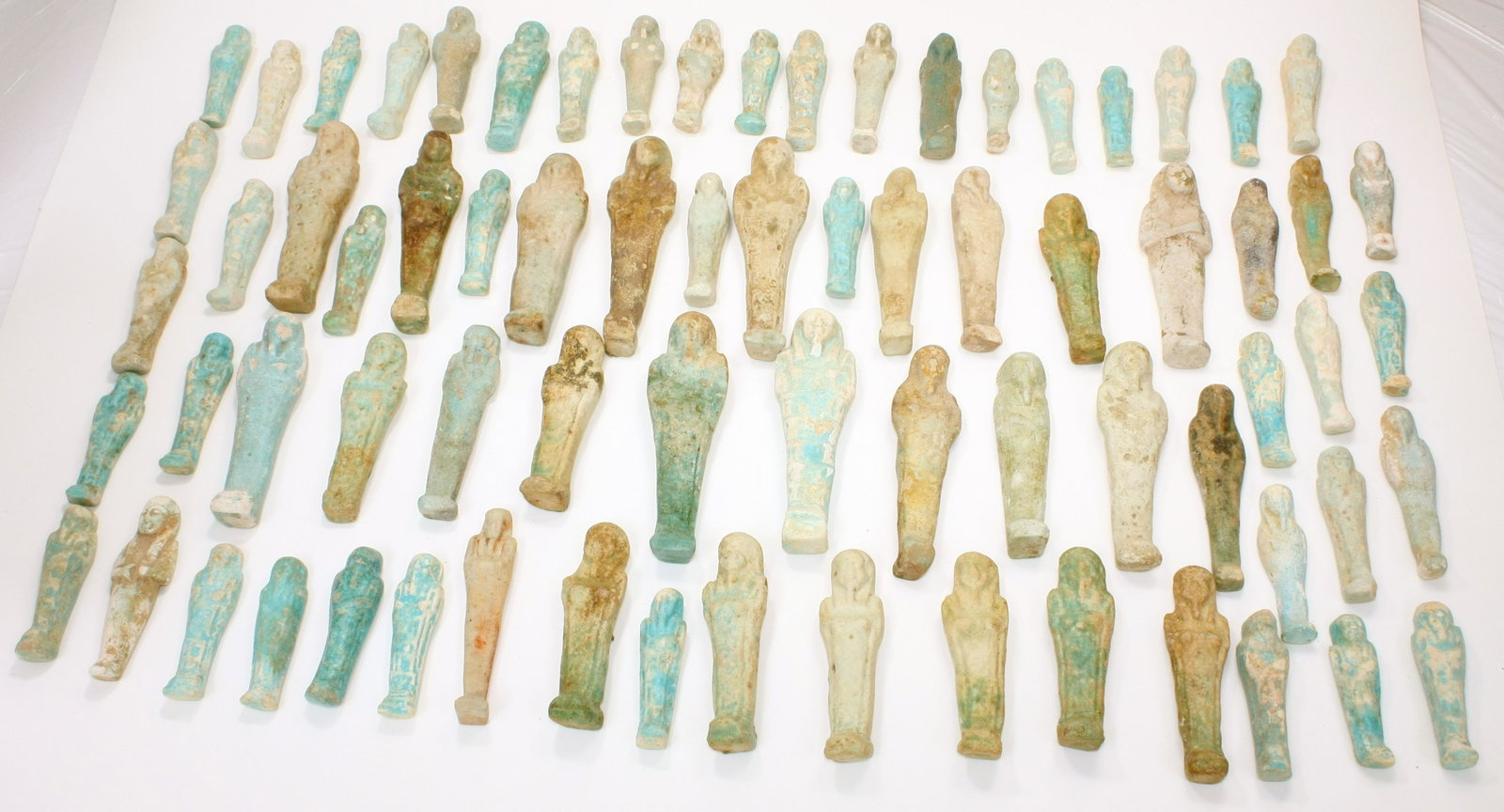 Lot of 73 Ancient Egyptian Faience Ushabti Figures: Lot of 73 Ancient Egyptian Faience Ushabti Figures c.700 BC. Size 3 - 5 inches high.(7.62-12.7 cm) A great collection of 73 blue and green glazed faience ushabti figures, some with Egyptian Hieroglyph