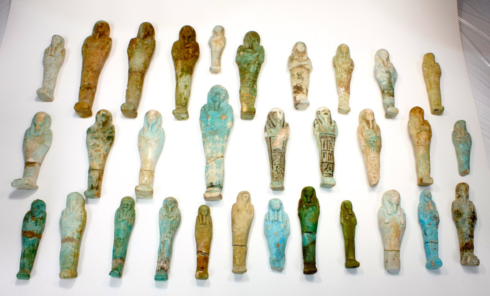 Lot of 31 Ancient Egyptian Faience Ushabti Figures: Lot of 31 Ancient Egyptian Faience Ushabti Figures c.700 BC. Size 6 1/2 - 3 3/8 inches high.(16.5-8.5 cm) A great collection of 31 blue and green glazed faience ushabti figures, some with Egyptian Hie