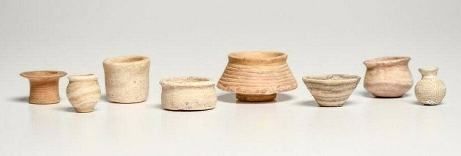 Lot of 8 Miniature Bactrian Stone Vessels c.2nd: Lot of 8 Miniature Bactrian Stone Vessels c.2nd millennium B.C. Size 3/4” to 1-1/4”H. Carved stone examples including seven different miniature alabaster bowls, have repairs or losses. Finally, a 