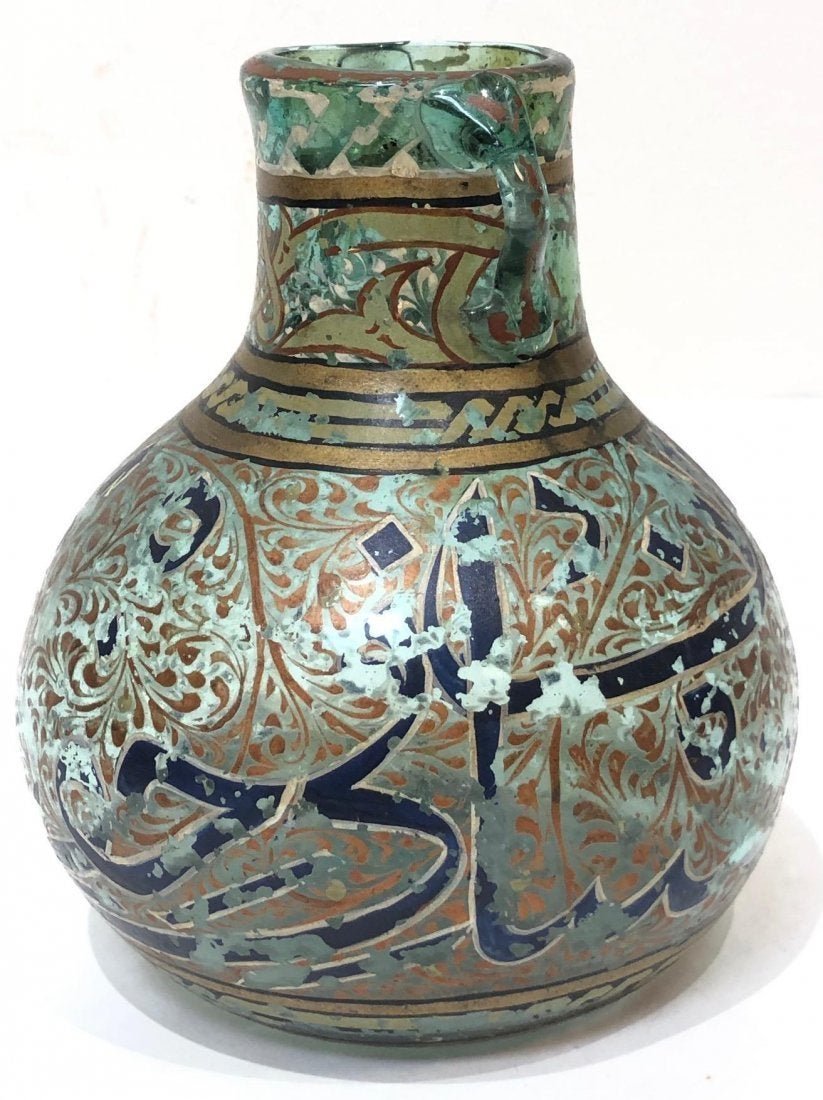 19th cent Islamic twin handled glass vase with enamel: 19th century Islamic twin handled glass vase with enamel and Arabic calligraphy size 6 inches high. Perfect.