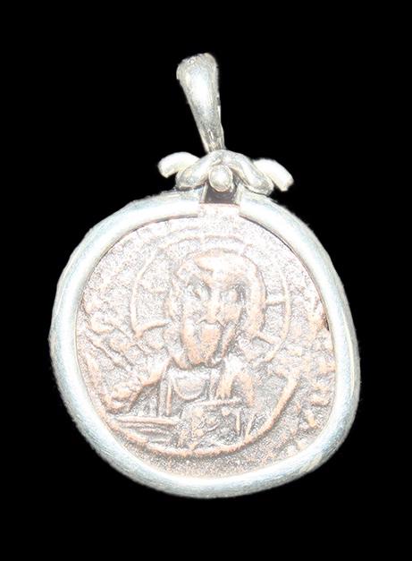 Ancient Byzantine Bronze Coin Of Christ c.1100 AD.: Ancient Byzantine Bronze Coin Of Christ c.1100 AD. Size 1 1/8 inches diameter. Ancient Byzantine Bronze Coin with Christ facing/Reverse with Latin inscriptions. Set in modern Silver Pendant. with susp