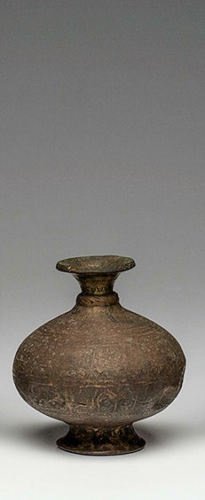 Persian Bronze Footed Vase c.18th century AD.: Persian Bronze Footed Vase c.18th century AD.Size 5 1/4 inches high. Fine squat globular vessel on low foot with incised design covering most of the surface. Numerous dents but intact.Provenance: Priv