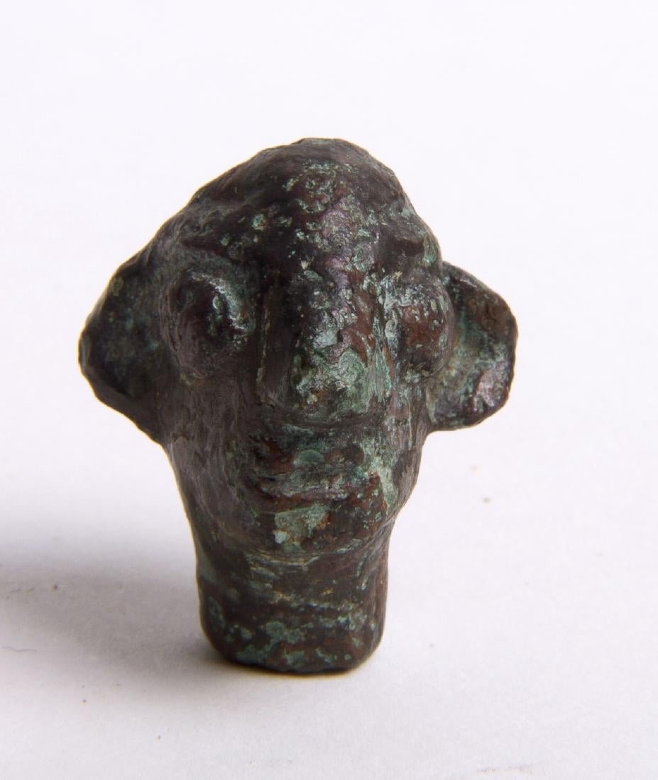 Ancient Canaanite Bronze Head of Baal c.2nd Cent BC.: Ancient Canaanite Bronze Head of Baal c.2nd Cent BC. Size 24 x 20 mm. Rare Ancient Baal head fragment from a full figure. Condition: Minor wear otherwise Perfect. Provenance: Ex The Time machine NYC. 