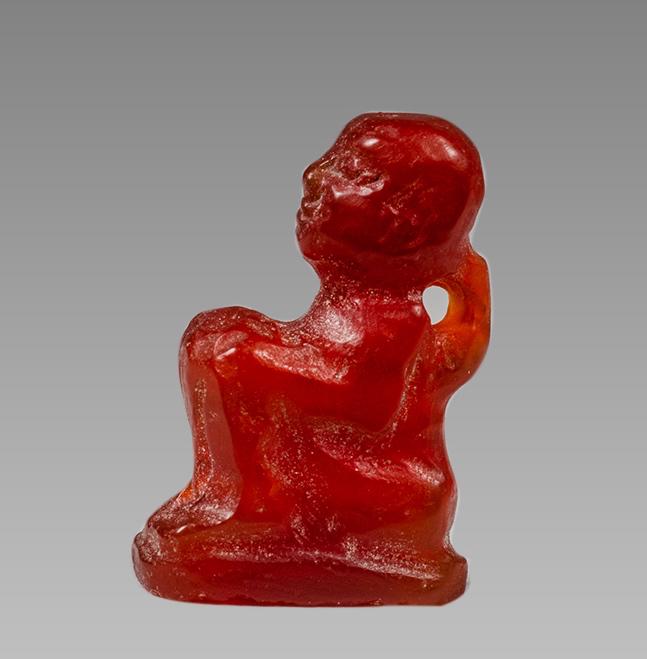 Ancient EGYPTIAN Carnelian Figure Amulet c.635-30 BCE.: Ancient EGYPTIAN Carnelian Figure Amulet c.635-30 BCE. Size 17 mm. Fine Carnelian seated figure of a king? amulet. Suspension loop on back. Provenance: Ex Secret Eyes Gallery New York 1970's-1980's.