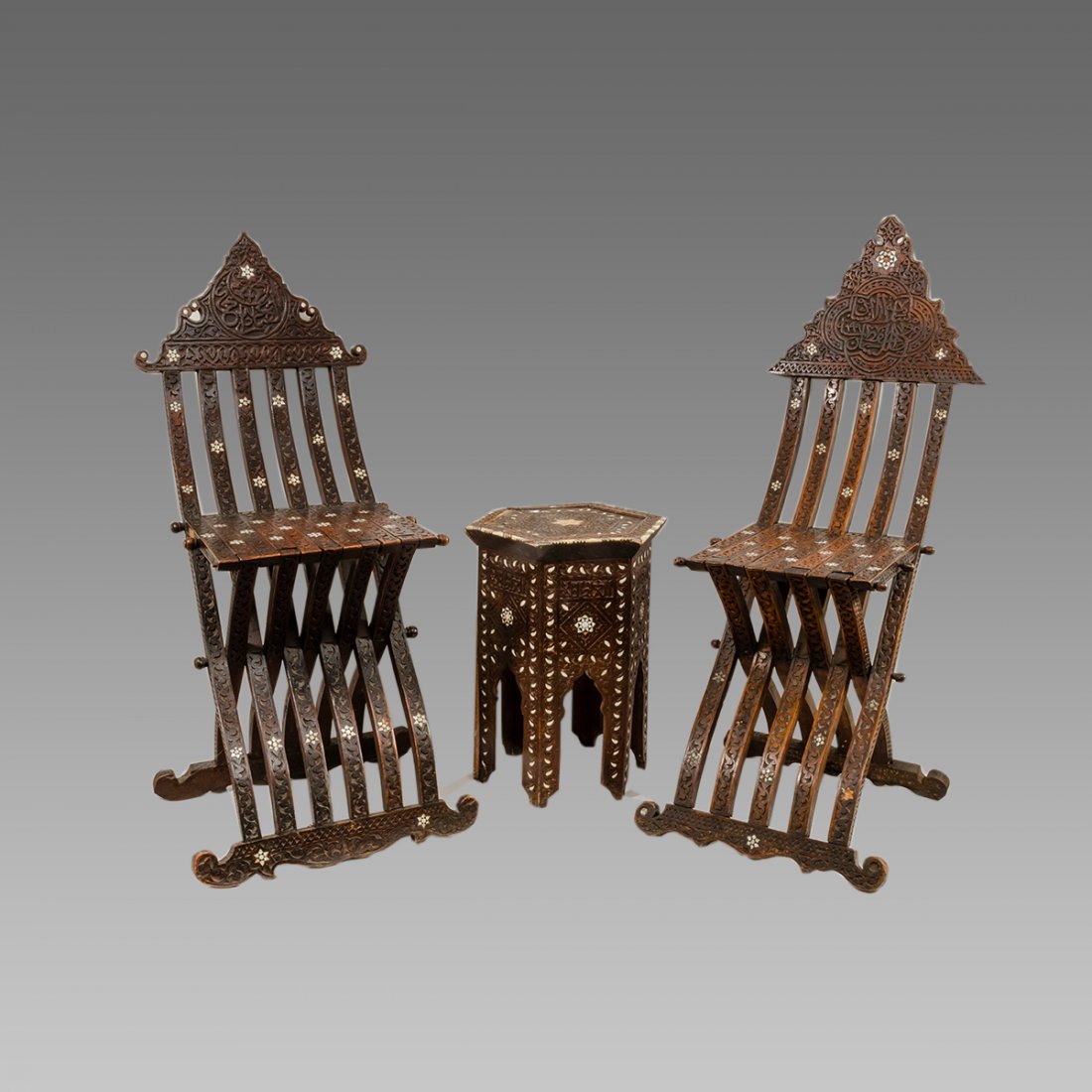 3 piece set of Syrian Chairs and Table c.19th century.: 3 piece set of Syrian Chairs and Table c.19th century. Size of the chairs 42 1/4 inches high x 14 inches wide. Table 19 5/8 inches high x 13 1/4 inches diameter. A matching set of folding wooden chair