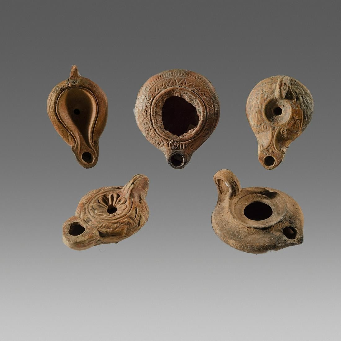 Lot of 5 Ancient Roman, Byzantine Holy Land Lamps: Lot of 5 Ancient Roman, Byzantine Holy Land Terracotta Oil Lamps c.1st-2nd century AD. Size 3 14 - 3 1/2 inches length. Great lot of 5 mixed types ancient Holy Land oil lamps. Great quality and value.