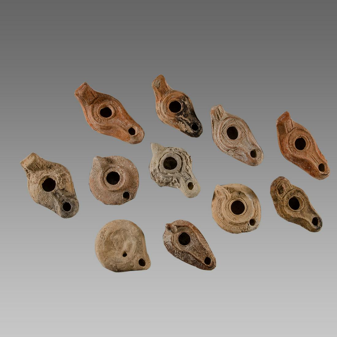 Lot of 11 Ancient Roman, Byzantine Terracotta Oil Lamps: Lot of 11 Ancient Roman, Byzantine Terracotta Oil Lamps c.1st-5th century AD. Size 3 1/2 - 4 3/4 inches length. Great lot of 11 Ancient Roman and Byzantine period terracotta oil lamps, one with a face