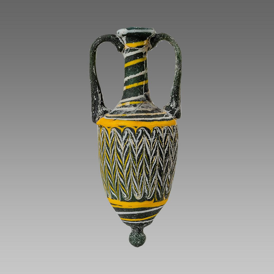 Phoenician Style Core glass Amphoriskos.: Phoenician Style Core glass Amphoriskos. Size 4 7/8 inches high. Phoenician style Core Glass Amphoriskos Sand core formed glass vessel in graceful amphora shape with acorn body on tiny foot, and round