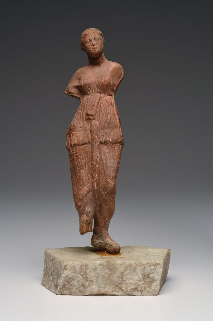 Ancient Roman-Egypt Standing Female Figure Ca. 1st cent: Ancient Roman-Egypt Standing Female Figure Ca. 1st century A.D. Size 8 inches high. Reddish-brown molded pottery standing armless female figure wearing an off the shoulder, two piece drapery garment, 