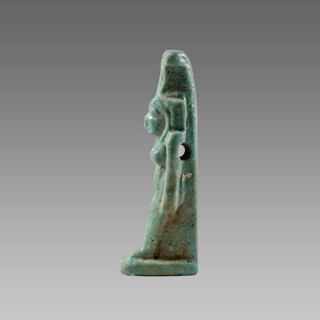 Ancient Egyptian Faience Amulet of Nephthys, c. 600: Ancient Egyptian Faience Amulet of Nephthys, c. 600 B.C.E. Size 1 1/2 inches high(35 mm). Glazed blue green faience amulet of Nephthys the sister of Isis, depicted standing on integral base wearing go