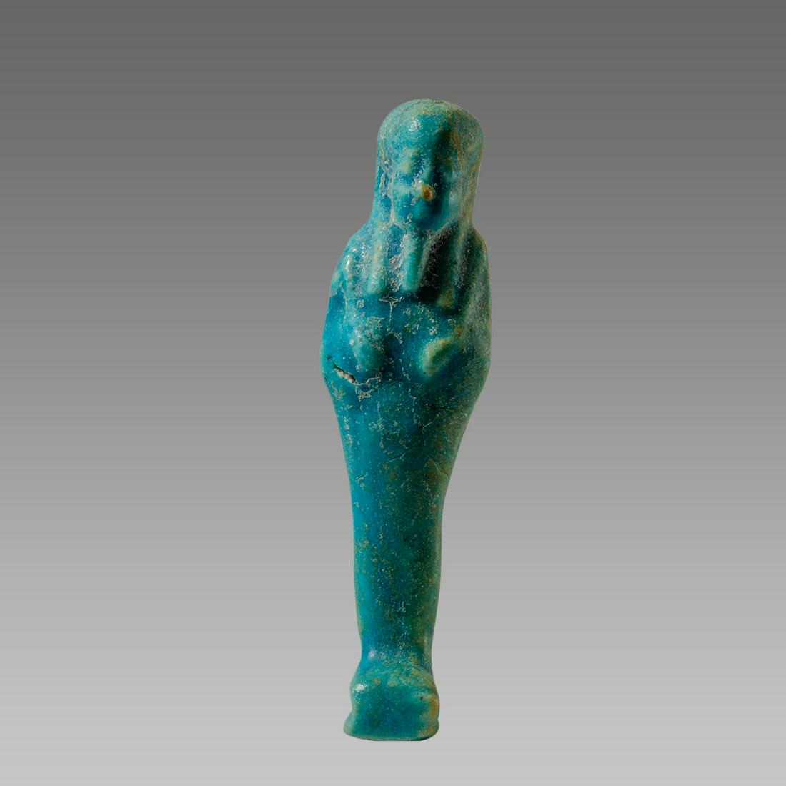 Ancient Egyptian Blue Faience Ushabti Late period: Ancient Egyptian Blue Faience Ushabti Late period c.664-30 BC. Size 4 1/2 inches high. Fine blue faience ushabti, mummiform figure standing on rectangular plinth with crossed arms holding the symbolic