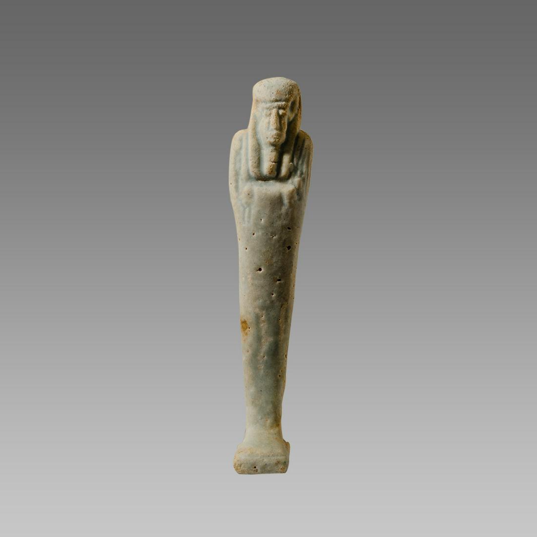 Ancient Egyptian White Faience Ushabti Late period: Ancient Egyptian White Faience Ushabti Late period c.664-30 BC. Size 4 inches high. Fine white faience ushabti, mummiform figure standing on rectangular plinth with crossed arms holding the symbolic p