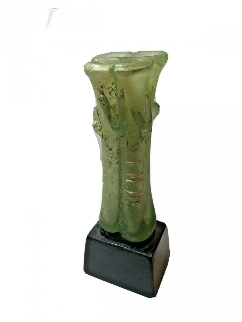 Ancient Byzantine TRANSLUCENT GLASS COSMETIC QUATRO: Ancient Byzantine TRANSLUCENT GLASS COSMETIC QUATRO UNGUENTARIA. Size 4 1/8 inches high. + stand. (the glass glued to a wooden base. Byzantine Period, 5th-6th century CE. 10.8 cm high. In very good co