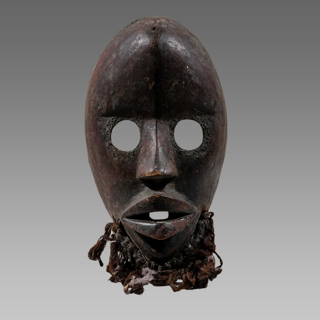 African Ivory Coast Wooden Mask With False beard.: African Ivory Coast Wooden Mask With False beard. Size 8 3/8 inches high. Carved wooden Dan mask with open eyes, false beard. Private New York City Collection.
