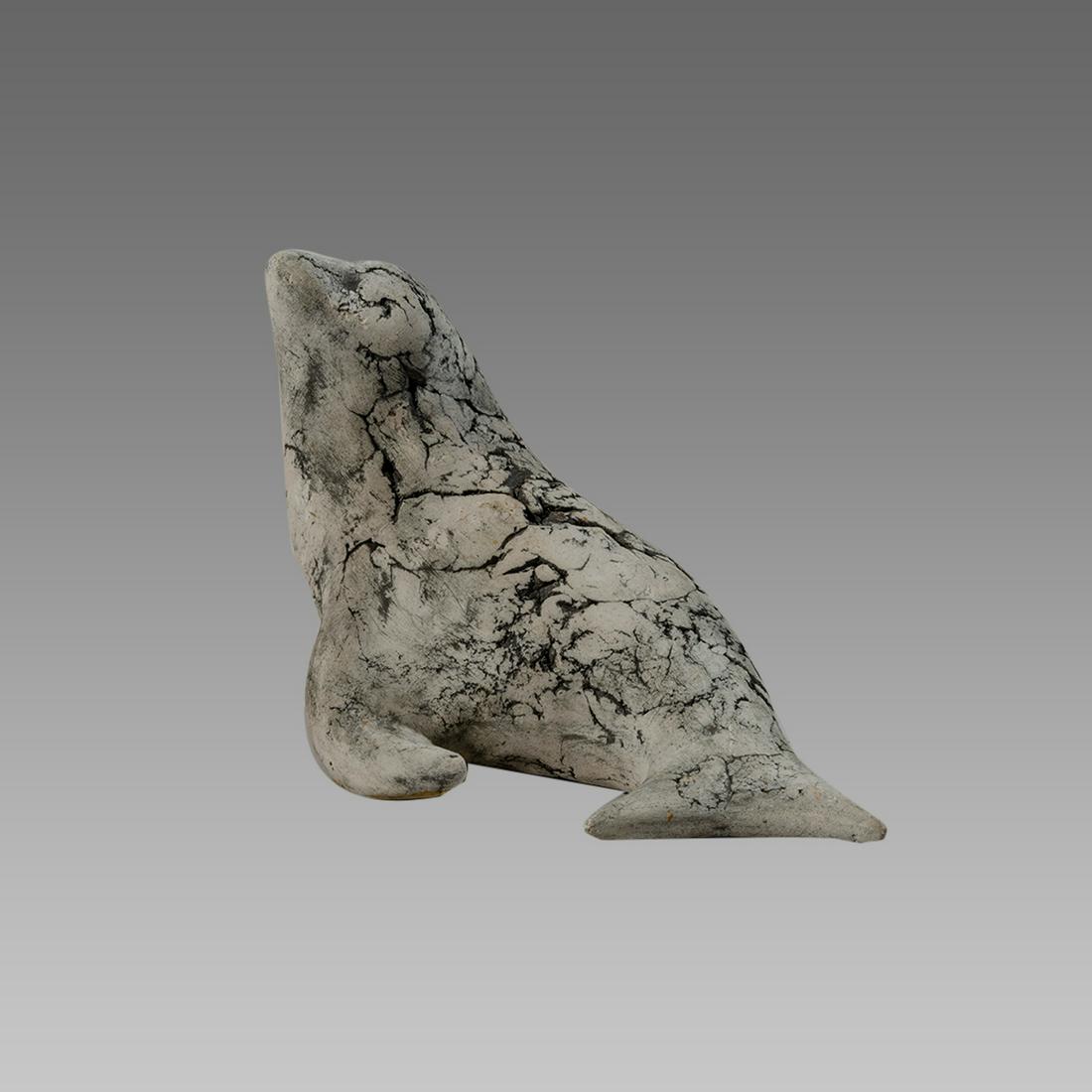 Native American, Eskimos soapstone sculpture of a seal.: Native American, Eskimos soapstone sculpture of a seal. Size 6 3/4 inches length x 4 1/2 inches high. Hand carved. Native American people of Canada and Alaska formerly known as Eskimos.