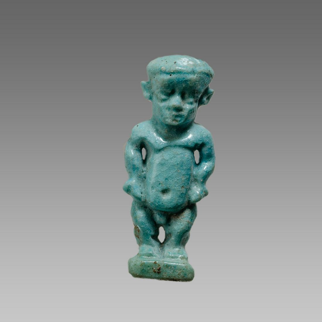 Ancient Egyptian Faience Dwarf Pataikos Amulet: Ancient Egyptian Faience Dwarf Pataikos Amulet c.664-525 BC. Size 1 3/8 inches high. Fine blue faience Pataikos amulet depicted as facing squating dwarf, in the round; loop for suspension to rear Ex P