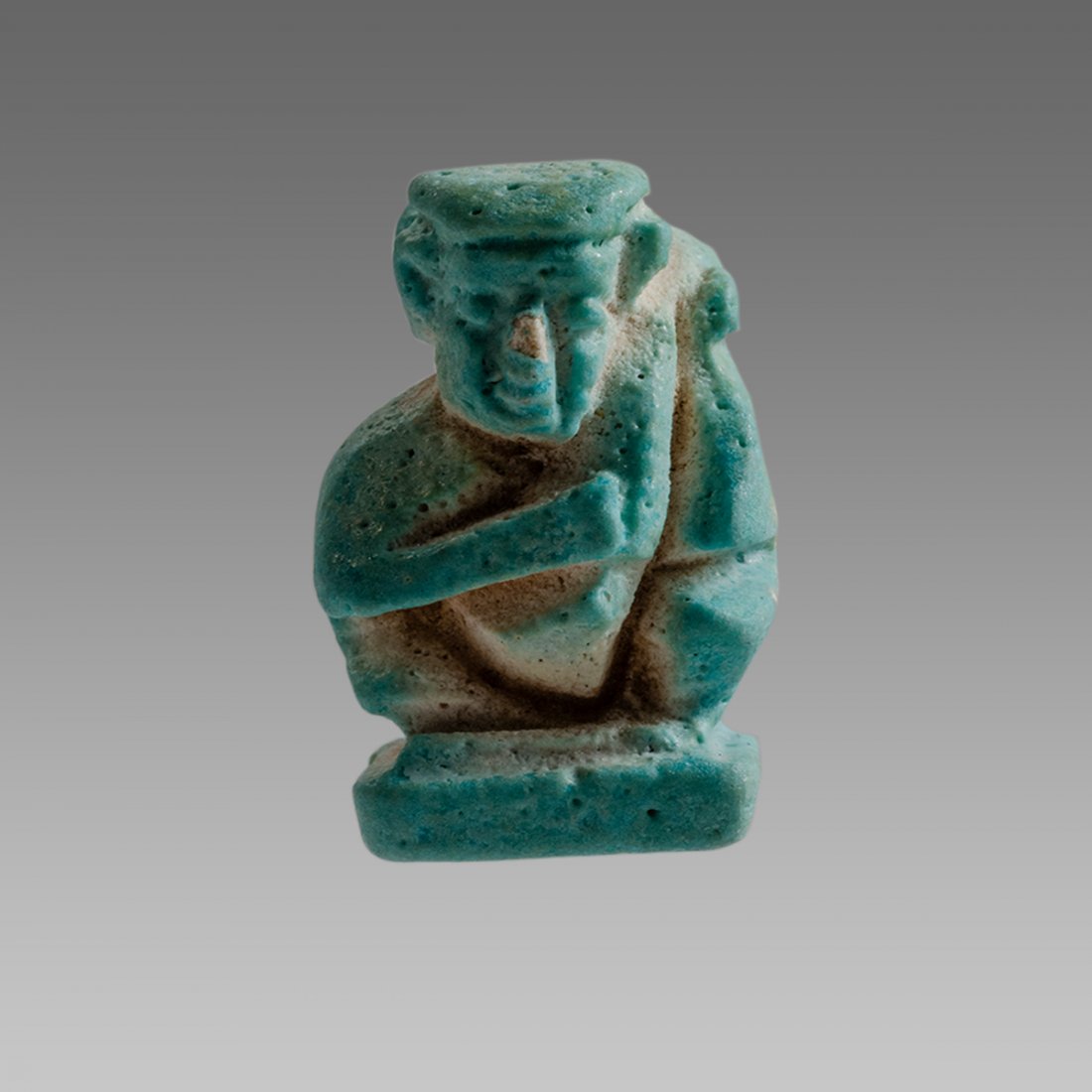 Ancient Egyptian Erotic Faience Amulet c.664-300 BC.: Ancient Egyptian Erotic Faience Amulet c.664-300 BC. Size 1 inch high. Fine faience amulet depicting erotic figure kneeling on a rectangular plinth, holding his enormous phallus with both hands as it 