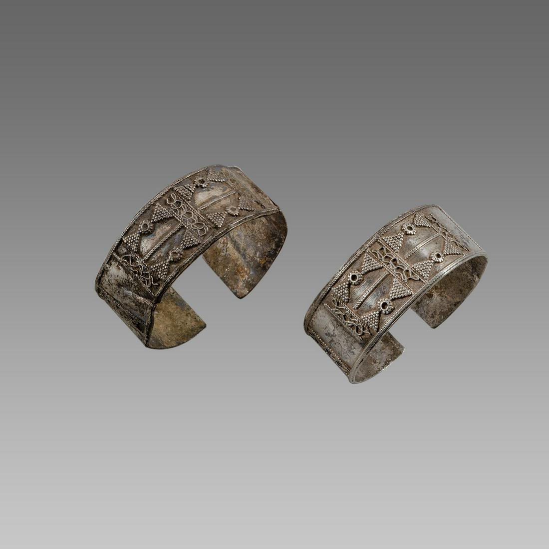 A pair of Islamic Silver Bracalets.: A pair of Islamic Silver Bracalets. Size 2 1/4 inches diameter. Fine silver bracalets decorated with raised ornate design.