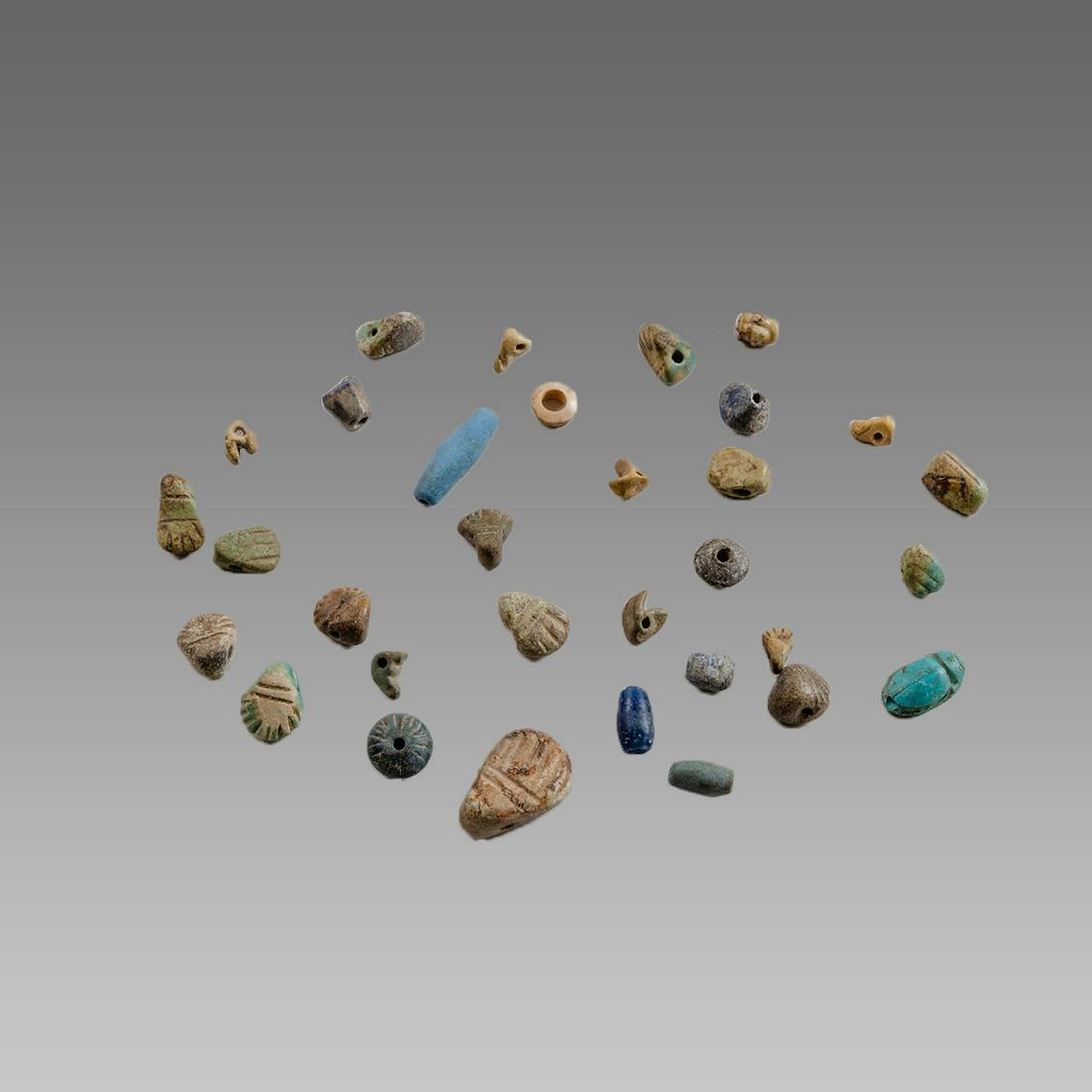 Lot of 35 Ancient Egyptian Faience beads c.3rd century: Lot of 35 Ancient Egyptian Faience beads c.3rd century BC. Size 9-21 mm. Nice collection of 35 faience beads and amulets. Ex Private New York city collection acquired in The New York Antique market.