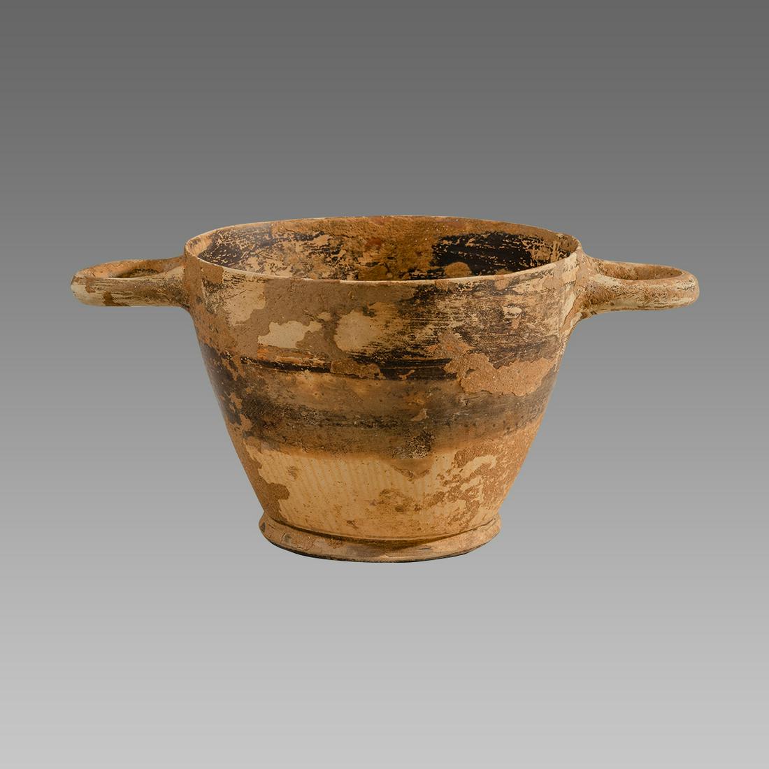 Ancient South Italian pottery Skyphos Circa 350 B.C.: Ancient South Italian pottery Skyphos Circa 350 B.C. Size 3 inches high. 6 1/4 inches across handle span. A Pottery vessel skyphos with twin handles. Provenance: Ex Private New York City collection ac