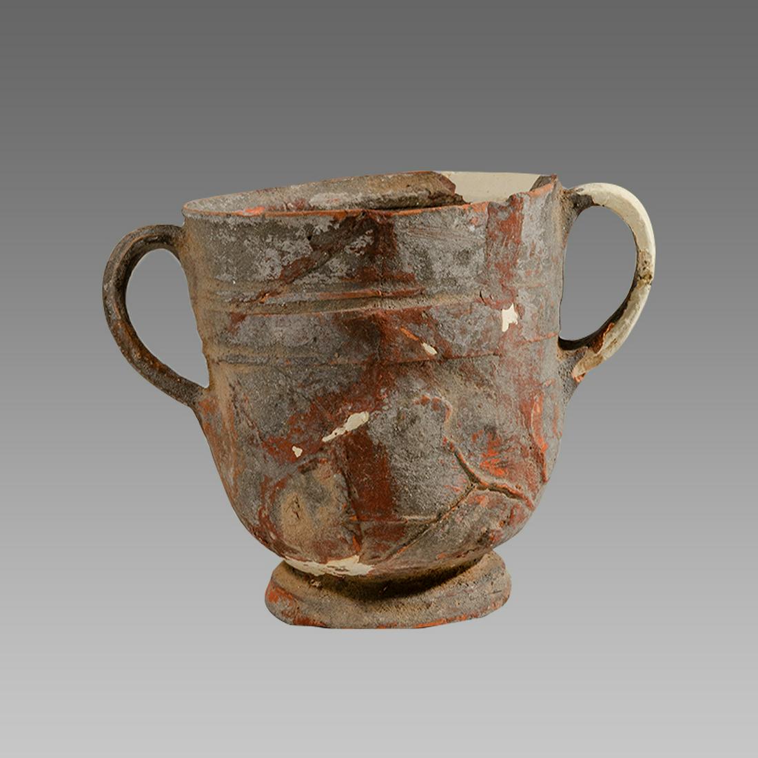 Ancient Roman Terracotta Cup Circa 2nd cent AD.: Ancient Roman Terracotta Cup Circa 2nd cent AD. Size 3 1/4 inches high. 5 inches across handles span. Terracotta cup with twin handles decorated with raised floral design. Provenance: Ex Private New Y