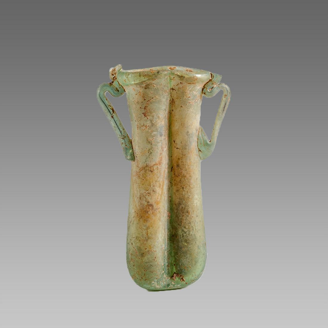 Ancient Roman glass Balsamarium c.2nd century AD.: Ancient Roman glass Balsamarium c.2nd century AD. Size 4 1/8 inches high. Great Form Ancient Roman glass Balsamarium bottle with twin handles with nice iridescence. Provenance: Ex Private New York cit