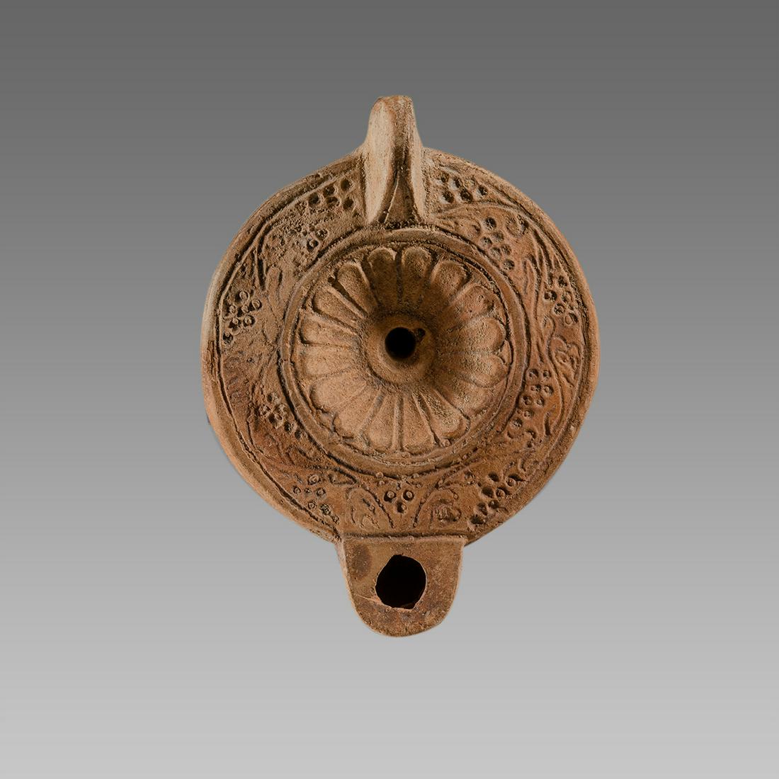 Ancient Roman North Africa Terracotta Oil Lamp c.2nd: Ancient Roman North Africa Terracotta Oil Lamp c.2nd century AD. Size 4 7/8 inches length. Fine terracotta oil lamp with floral design. Provenance: Collection of Henry Gerson acquired from Tunesia 197