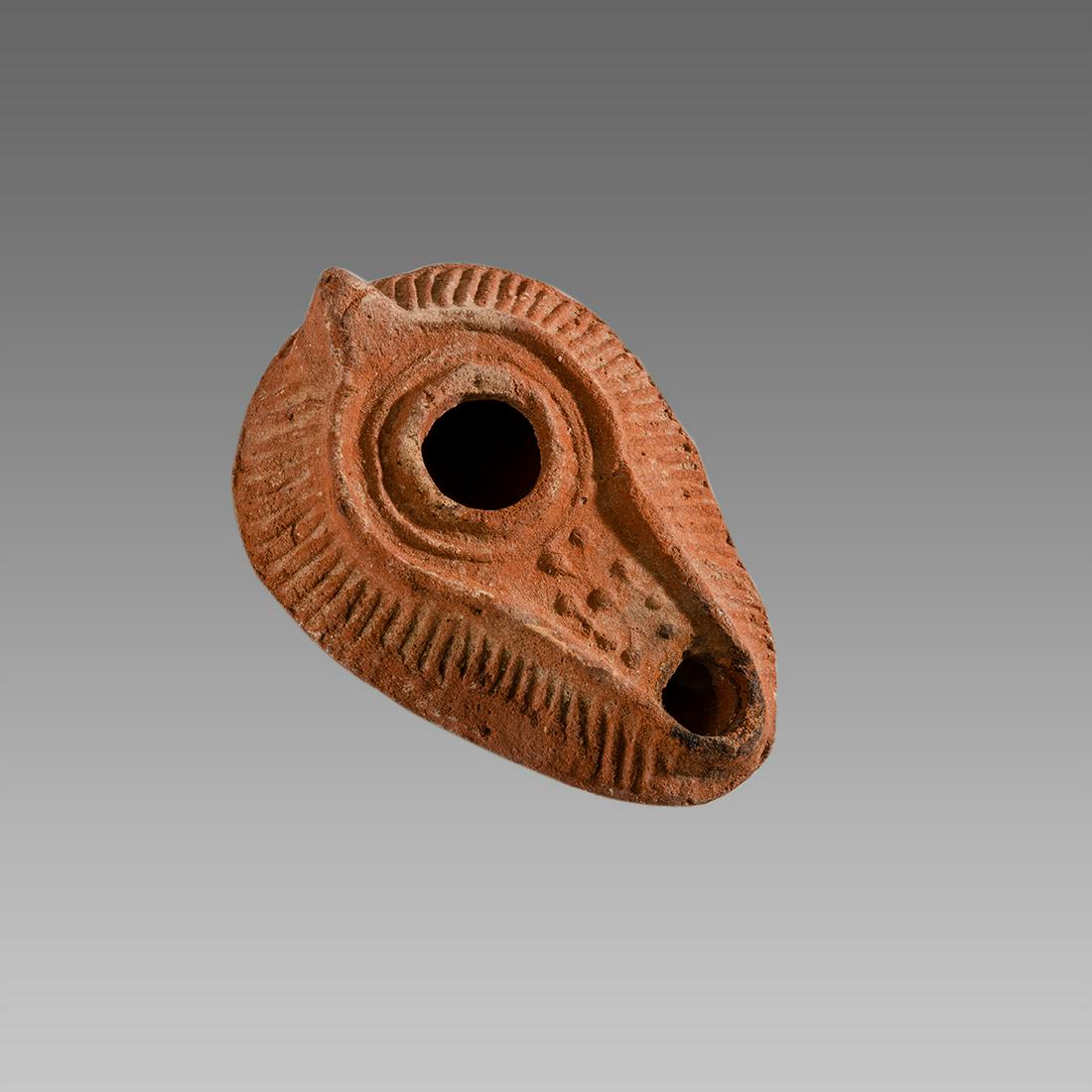Ancient Holy Land Byzantine Terracotta Oil Lamp with: Ancient Holy Land Byzantine Terracotta Oil Lamp with Cross c.6th cent AD. Size 4 inches length. Fine terracotta Oil lamp with a Cross at the spout, decorated shoulder. Provenance: From MO, USA estate.