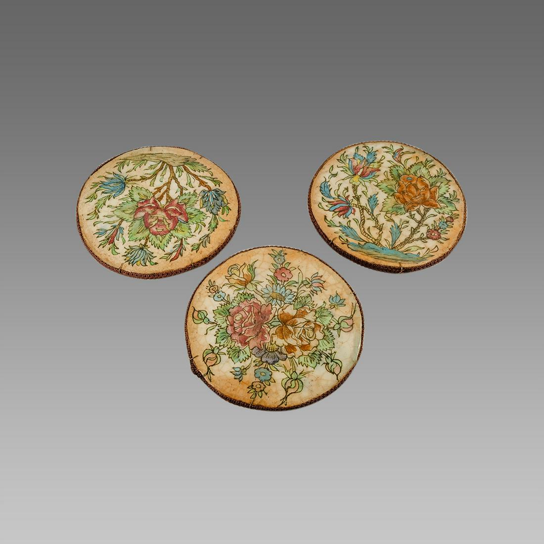 Lot of 3 Persian Cermaic Tiles.: Lot of 3 Persian Cermaic Tiles. Size 9 1/4 inches diameter. each decorated with floral design. back with hanger.