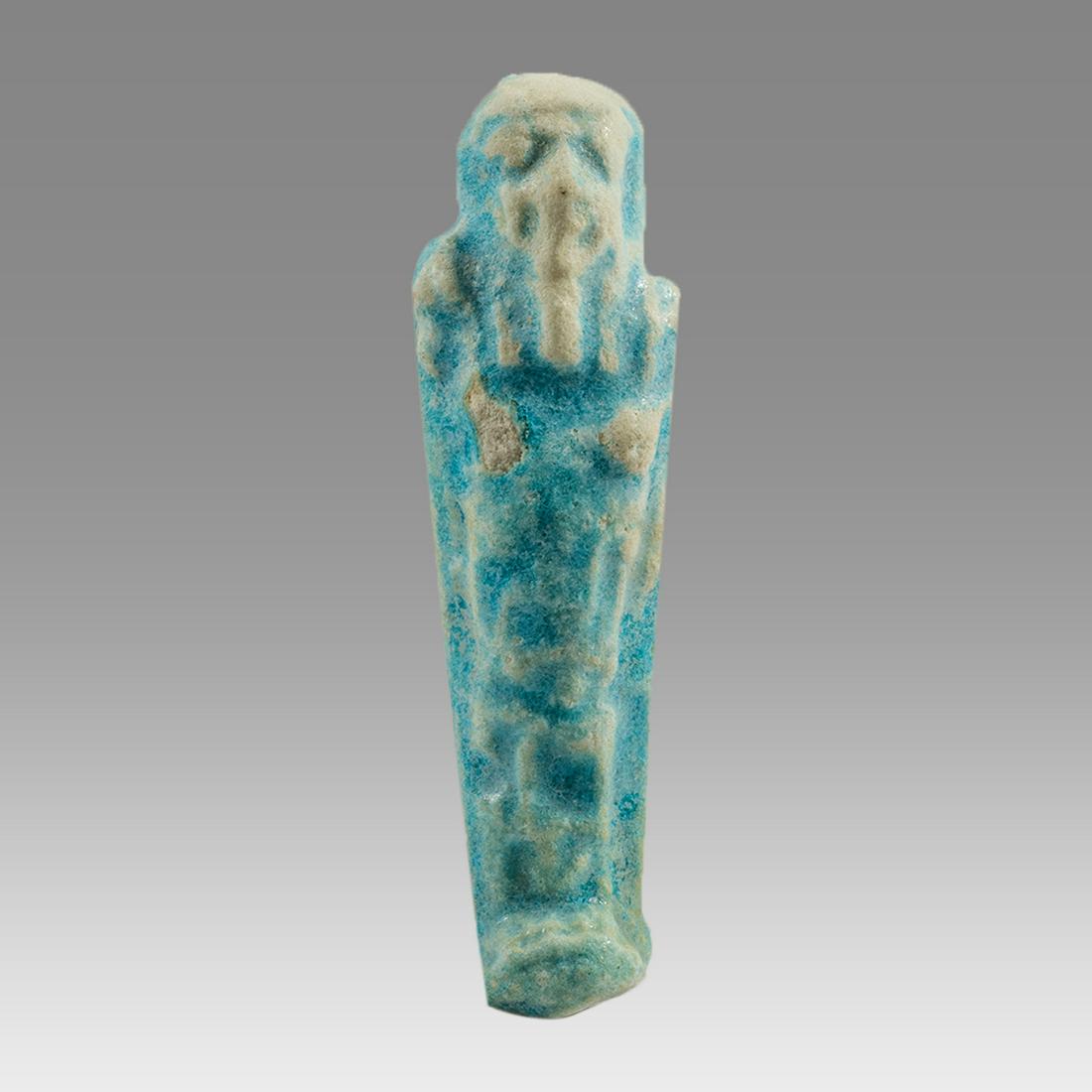 Ancient Egyptian Faience Ushabti Late Period c.300 BC.: Ancient Egyptian Faience Ushabti Late Period c.300 BC. Size 2 3/4 inches high. Fineblue faience Ushabti figure with hieroglyph text in the center. Provenance: Ex Private Charlotte, North Carolina USA 