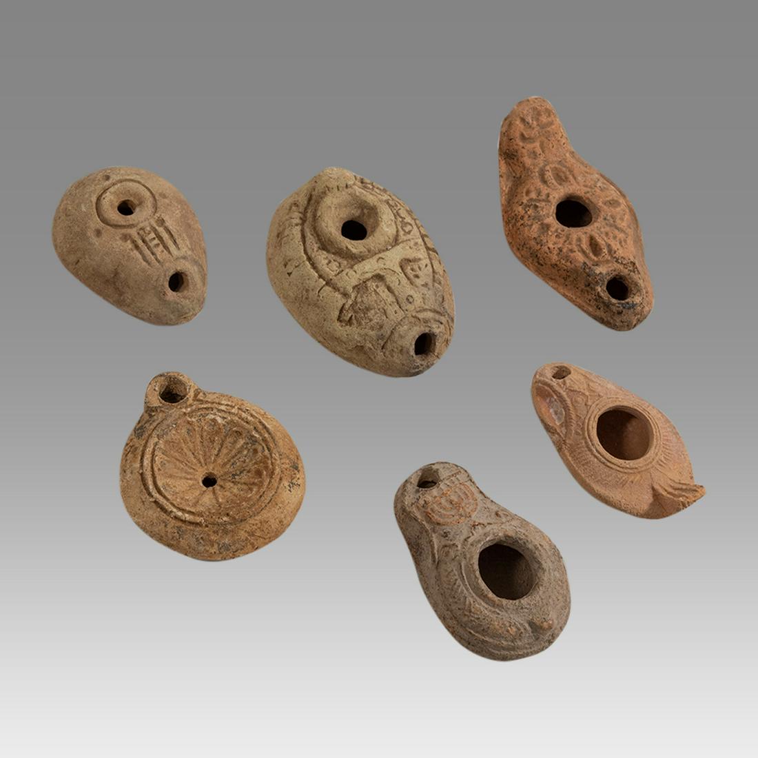 Lot of 6 Ancient Egyptian and Roman Terracotta Oil: Lot of 6 Ancient Egyptian and Roman Terracotta Oil Lamps ca. 200 AD. Size: 3 1/8 - 4 inches length. Lot of 2 Egyptian Roman Terracotta oil lamps together with 4 Holy Land Roman oil lamps (menorah lamp