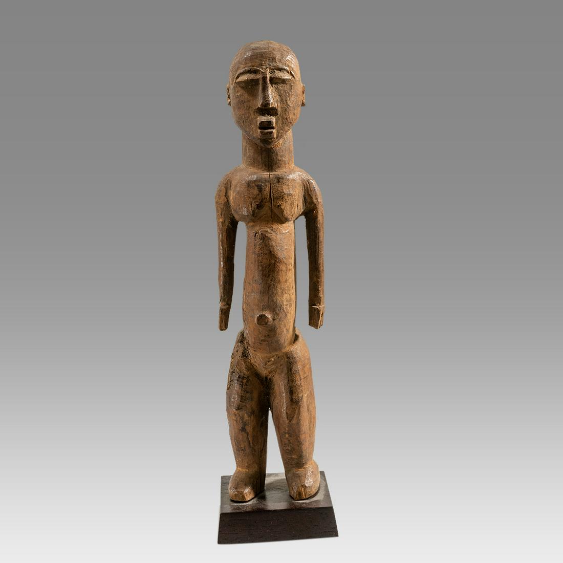 African Lobi Wood Ancestor Figure Burkina Faso or Mali.: African Lobi Wood Ancestor Figure Burkina Faso or Mali. A hard wood carved stylized standing male figure with bulging eye lids, jutting jaw, hands to sides and angular breasts. A good old piece. Size 