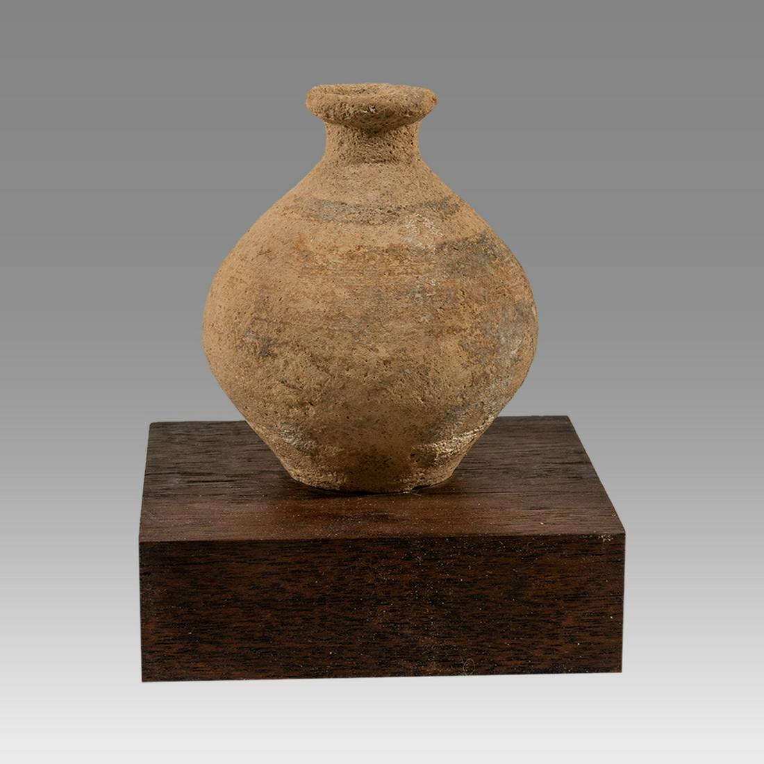 Ancient Holyand Pottery Aryballos Canaanite Period, Ca: Ancient Holyand Pottery Aryballos Canaanite Period, Ca 1500 BC. Buff clay bulbous vase with constricted spout, Good deal of earth encrustations. Intact. Size 3-1/2 inches H. 5 inches on wood block bas