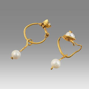 Ancient Roman Gold Pair of Earrings c.1st century AD.: Ancient Roman Gold Pair of Earrings c.1st century AD. Size 22 mm. weight 2.3 grams. High karat pair of gold earrings with pearl beads. Provenance: Private NYC Collection acquired in the USA Market.