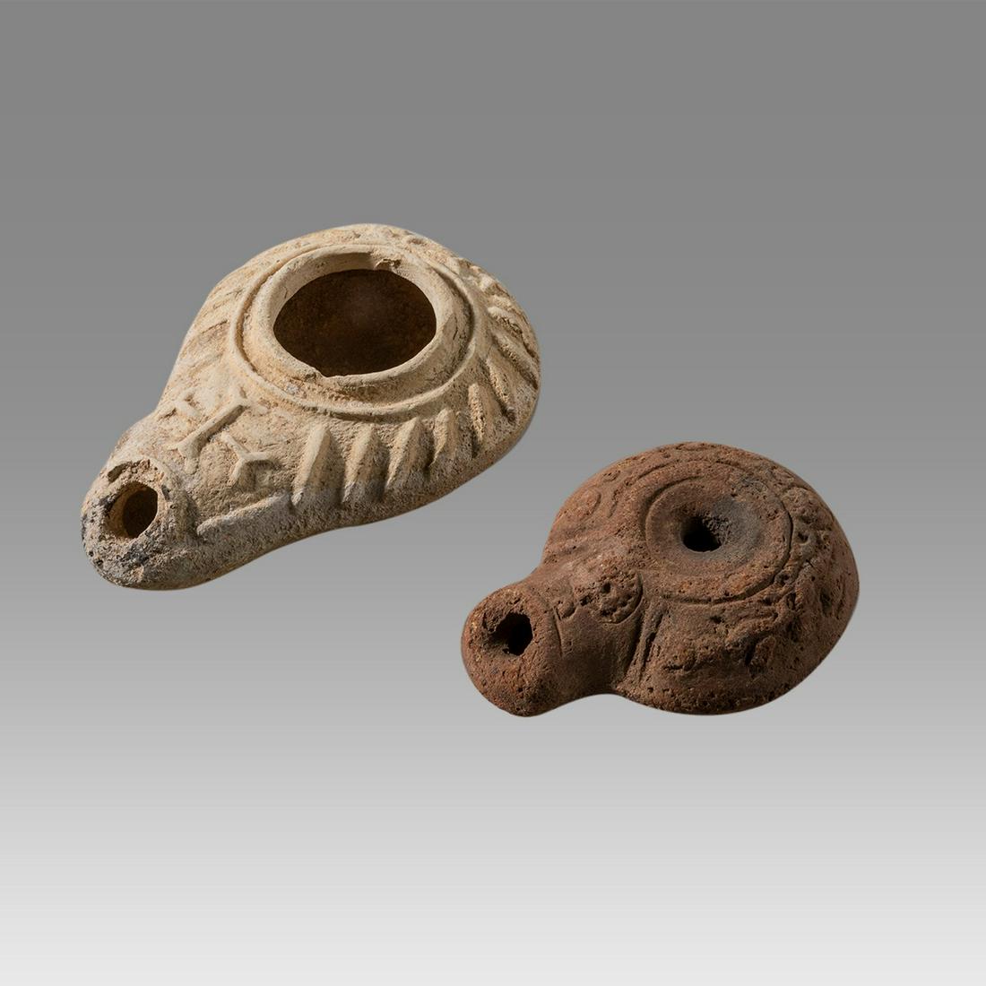 Lot of 2 Ancient Roman, Byzantine Terracotta Oil Lamps c.2nd-5th century AD.: Lot of 2 Ancient Roman, Byzantine Terracotta Oil Lamps c.2nd-5th century AD. Size 3 3/4 - 3 inches length. fine ancient RomanEgypt terracotta oil lamp decorated with wreath together with Byzantine Oil