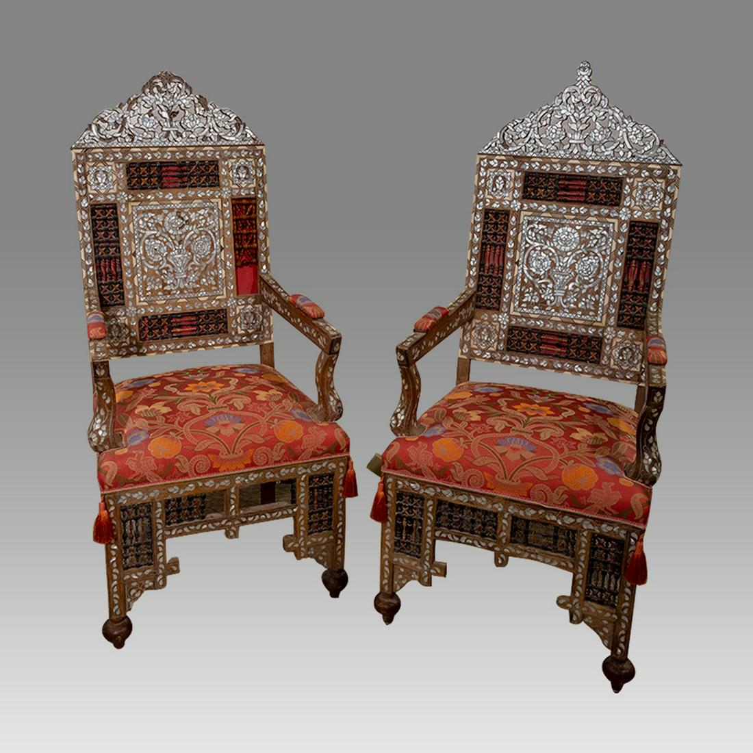 19th cent Syrian Mother of Pearl Inlaid arm chairs.: 19th cent Syrian Mother of Pearl Inlaid arm chairs. Size height 49 inches. Antique pair of Wood Arm Chairs with mother pearls floral design, silk upholstery. Original silk.
